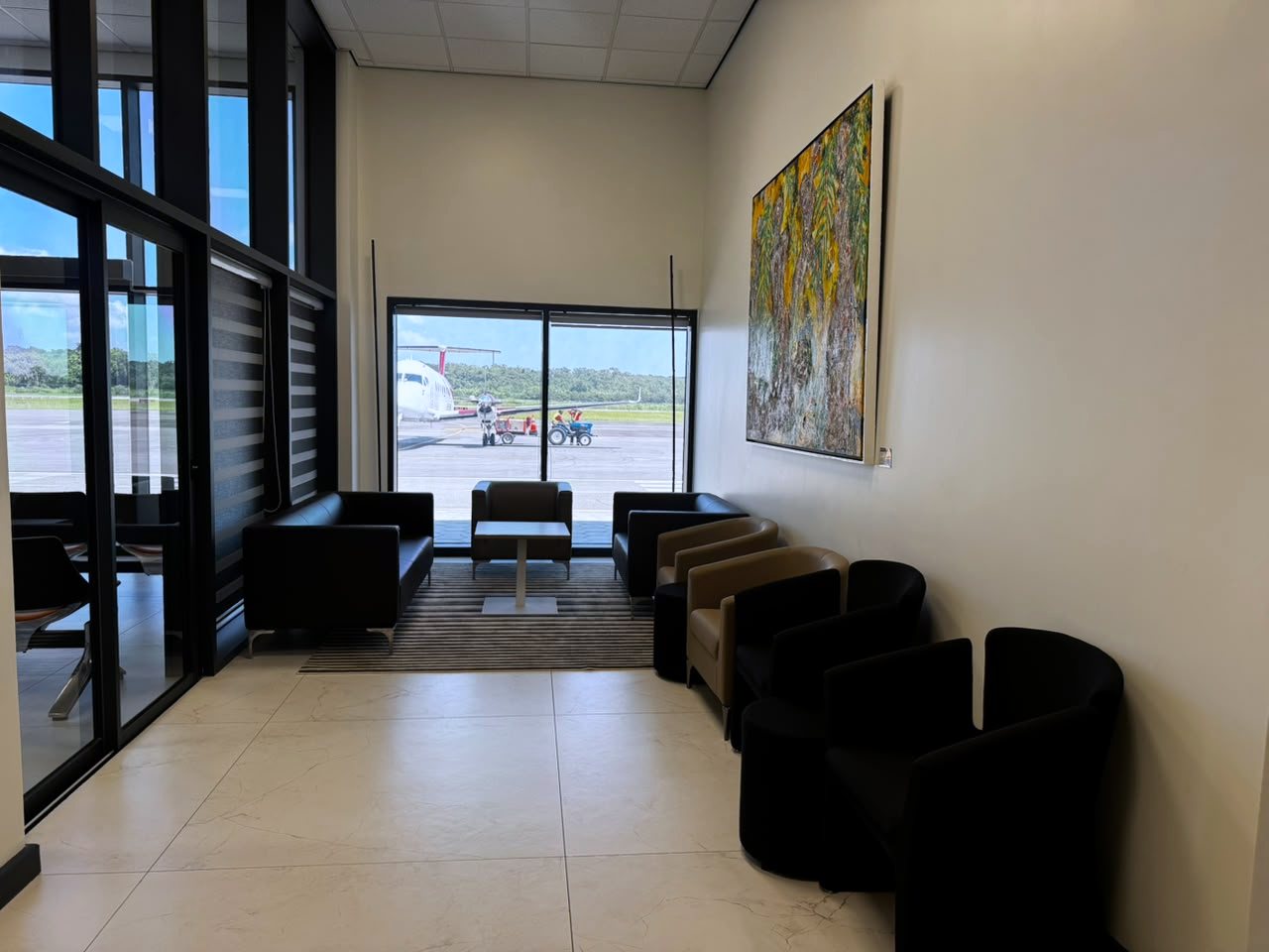 The VIP Courtesy Lounge at EAG, with seating facing the apron and an aircraft on stand